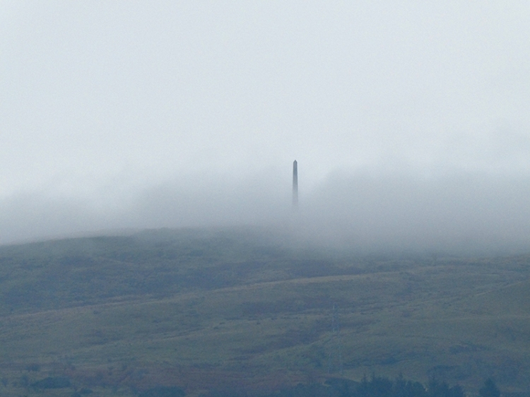 monument in low cloud